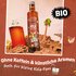 Kola Sirup Flasche in Strandszene mit Getränk, Palme und Text „BIO“ sowie „Ohne Koffein & künstliche Aromen auch für kleine Kola-Fans“