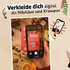 Hand hält Smartphone, Text: "Verkleide dich digital als Nikolaus und Krampus"